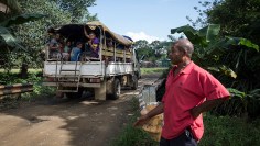 A man stands next to a bridge on the East Cape Road. The East Ca